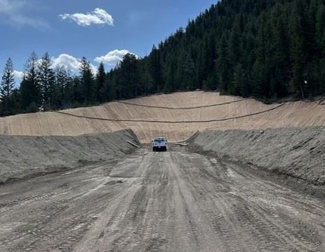 A photo of the construction of the shooting range in Dumont with dirt, blue sky, and a mountian.
